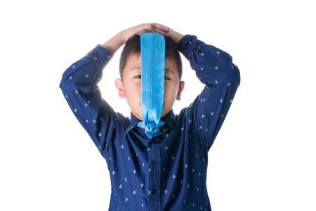 Asian boy with necktie on face, isolated on white background.の写真素材
