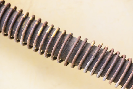 old hydraulic hose with rusty coil spring at tractor for background textureの写真素材