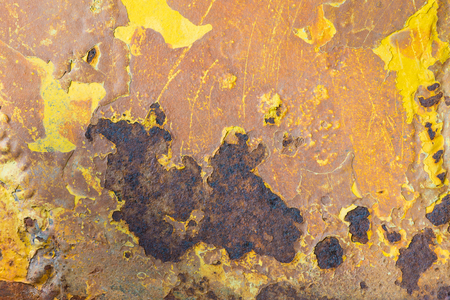rusty on old metal and peeling off paint yellow color, texture background.