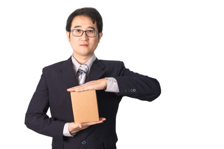 Asian businessman giving and carrying parcel, cardboard box, isolated on white backgroundの写真素材