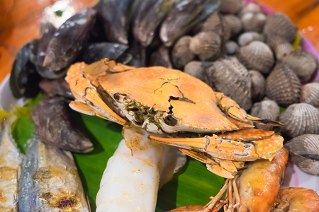 Seafood on white dish, Seafood platter on wood table, shallow DOF