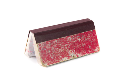 Old red account book with soft shadow, isolated on white backgroundの写真素材