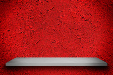Empty top of white shelves on red wall with bright center spotlight and black vignette border frame with vintage grunge background texture, for product display. for put product on shelves.の写真素材