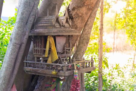Ancient Thai outdoor spirit house shrine Thai style made from wood. In tradition Thailand all spirit houses are kept outdoor for protect house.の写真素材