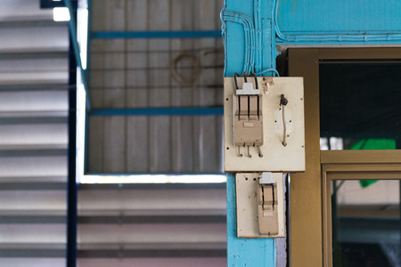 Old electrical power safety breaker with socket outlet on the wallの写真素材