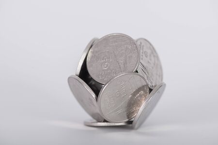 Group of coins, piles of coins arranged ball shape on white background, business idea, shallow...