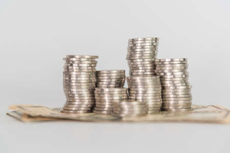 Savings, piles of coins and American dollar currency on white background, business idea. shallow focusの写真素材