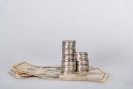 Savings, piles of coins and American dollar currency on white background, business idea. shallow focusの写真素材