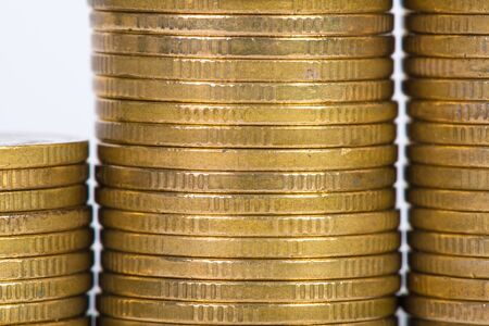 Columns of gold coins, piles of coins arranged isolated on white background, business banking idea,...