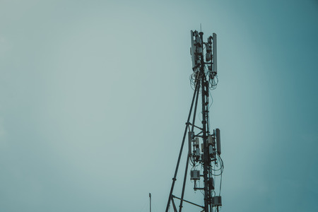 Antennas of cellular and communication systems with the blue sky, signal transmitter. vintage tone with vignetting.の写真素材