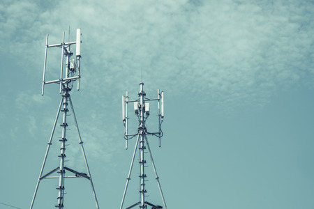 Antennas of cellular and communication systems with the blue sky, signal transmitter. vintage tone with vignetting.の写真素材