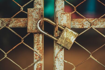Closed metal lock door security protection padlock. private place.  vintage tone.の写真素材