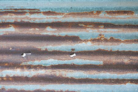 Old rusty corrugated tin zinc metal wall in vintage tone with vignetting.のeditorial素材