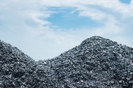 Pile of gravel gray stone prepare for mix concrete in construction with blue sky. material.