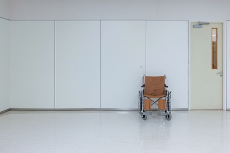 Empty wheelchair to patient or disabled parked in empty room at hospital. health care concept.の写真素材