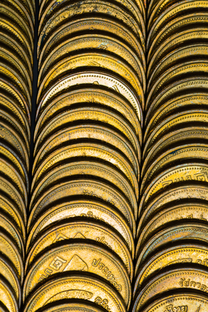 Columns of gold coins, piles of coins arranged background, business banking idea.の写真素材