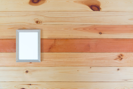 Top view of empty wood photo frame on bright wooden table with copy space, picture memory.の写真素材