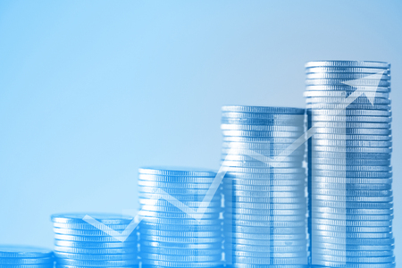 Double exposure stacks of coins on working table with copy space, finance and business concept, shallow focus.の写真素材