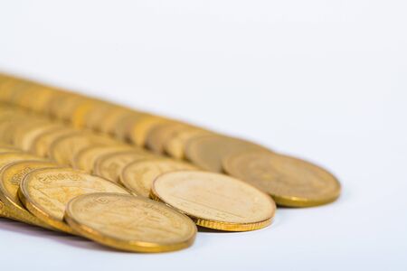 Columns of gold coins, piles of coins arranged on white background, business banking idea.