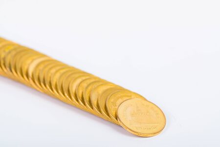 Columns of gold coins, piles of coins arranged on white background, business banking idea.の写真素材