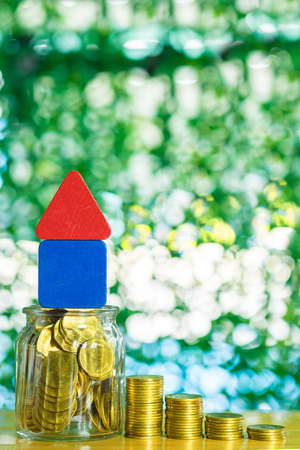 Model house wood form with step of coins stack on table, real estate investment and saving banking money finance concept.の写真素材