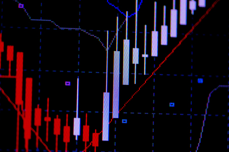 Candle stick graph chart with indicator showing bullish point or bearish point, up trend or down trend of price of stock market or stock exchange trading, investment and financial concept. thin focus.の写真素材