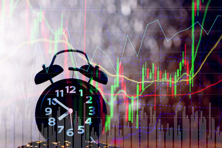 Double exposure of alarm clock and coin with candle stick graph chart, time for savings money...
