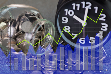 Double exposure of alarm clock and step of coins stacks with coin in glass jar and financial graph, time for savings money concept, banking and business idea.の写真素材