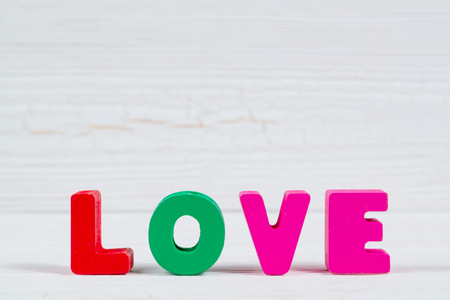 Valentine card with Love text on white wooden background and copy space for add text and picture, love and valentine day concept idea.の写真素材