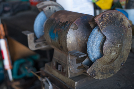 Circular wire grinding brush machine. Steel polisher in garage.の写真素材