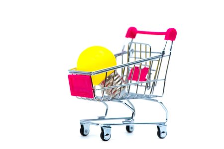 Mini shopping cart or supermarket trolley with yellow tungsten light bulb, isolated on white background, business finance shopping concept idea.の写真素材