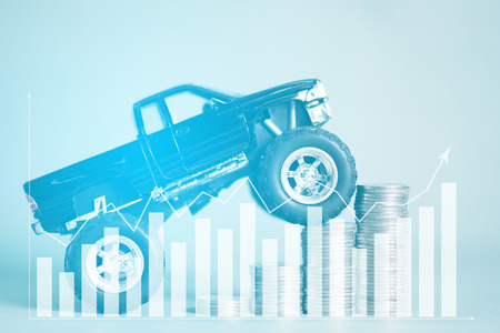 Miniature car pickup truck on stair of coins stacks with financial graph and copy space, banking savings money and business finance concept idea.の写真素材