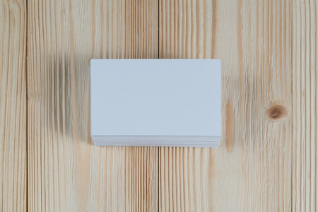 Blank business cards on wooden working table with copy space for add text ID. and logo, business company concept idea.の写真素材