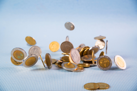 Falling coins money on blue background, business wealth concept idea.の写真素材
