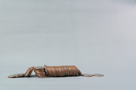 Column of coins, pile of coins on gray background, business and finance concept idea.の写真素材