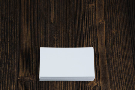 Blank business cards on wooden working table with copy space for add text ID.