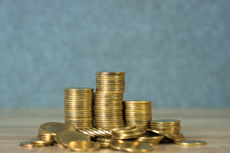 Columns of gold coins, piles of coins on working table, business banking and financial concept idea.
