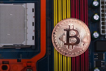 Bitcoin digital currency,  bit-coin on motherboard or electronic board with chips, Cryptocurrency...