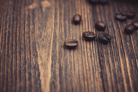 Roasted coffee beans on dark brown wood table. coffee background with copy space for add text.の写真素材