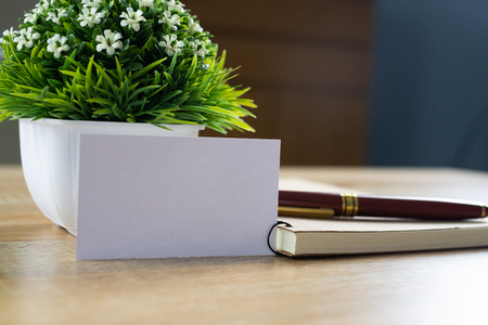 Blank business card or name card with space for add text name address and logo with notebook organizer on working table, financial company concept idea.の写真素材