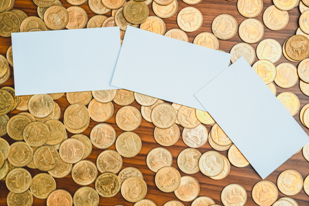 Blank business card or name card with copy space for add text name address and company logo, stack of coin on working table, financial company concept idea.の写真素材