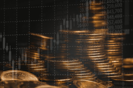 Double exposure of coin stack with stock market screen chart board and candle stick for financial business and investor analysis concept idea.の写真素材