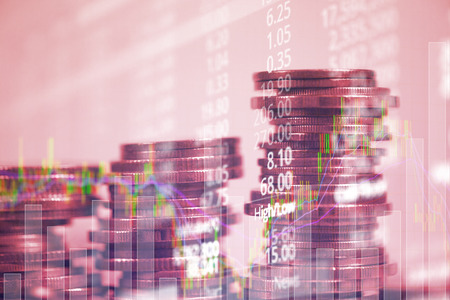 Double exposure of coin stack with stock market screen chart board and candle stick for financial business and investor analysis concept idea.の写真素材