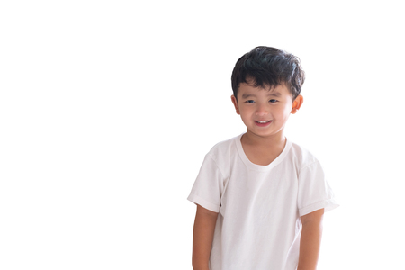 Asian kid boy in white t-shirt standing and smiling, isolated on white background with clipping path.の写真素材