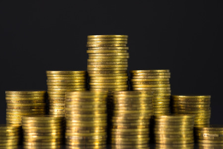 Increasing columns of coins, step of stacks coin on dark background with copy space for business and...