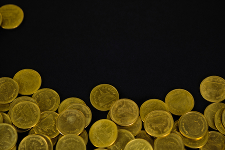 Piles of coins on black background, business and financial concept idea.の写真素材