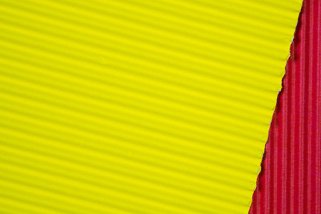 Red and yellow corrugated paper texture, use for background. vivid colour with copy space for add text or object.の写真素材
