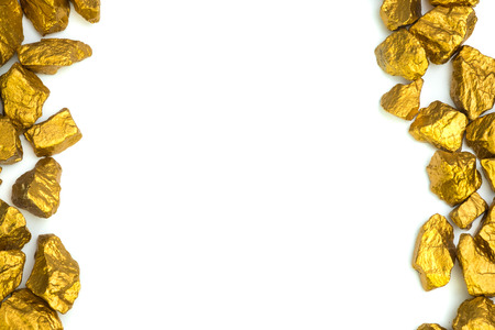 A pile of gold nuggets or gold ore on white background, precious stone or lump of golden stone, financial and business concept idea.の写真素材