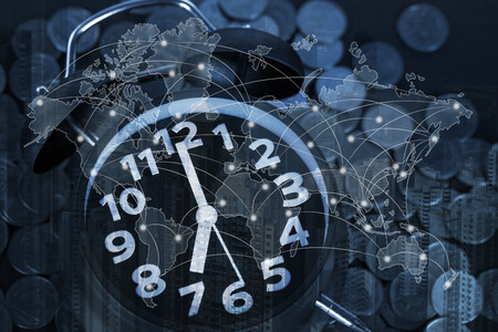 Double exposure of coin stack and alarm clock with city background and world map, financial graph, world map and global network business concept ideaの写真素材