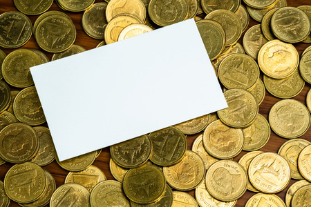 Blank business card or name card with copy space for add text name address and company logo, stack of coin on working table, financial company concept idea.の写真素材